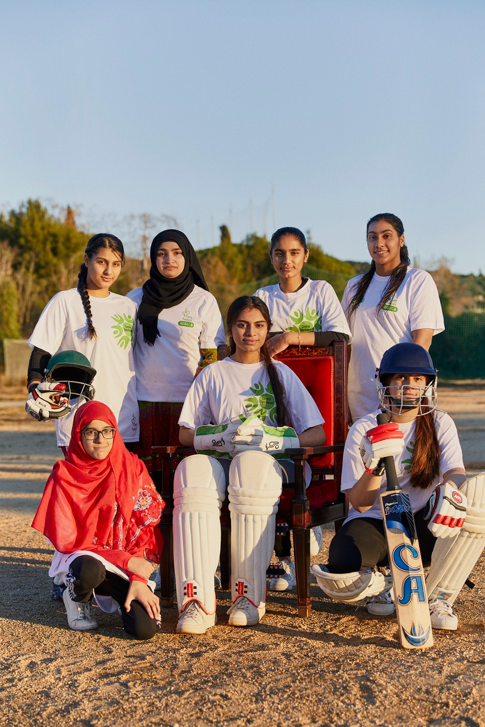 A women's team of cricketers posing for a team photo