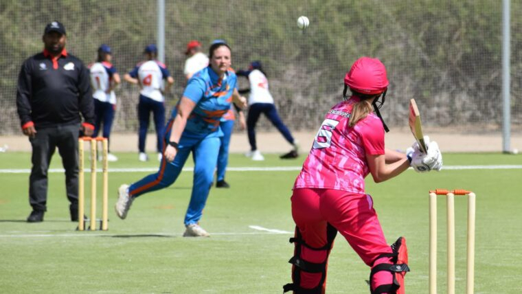 Cricketer attempting to deflect a shot while on the field of play